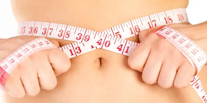 keeping-a-diet-and-fitness-rutine-measuring-tape-around-a-waist-woman